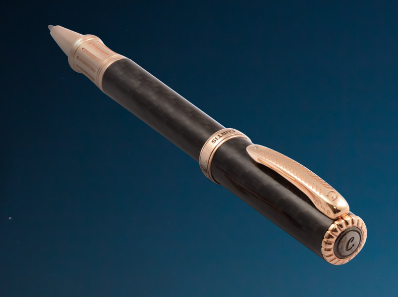 Luxury carbon fiber pen with solid rose gold grip, clip and tip