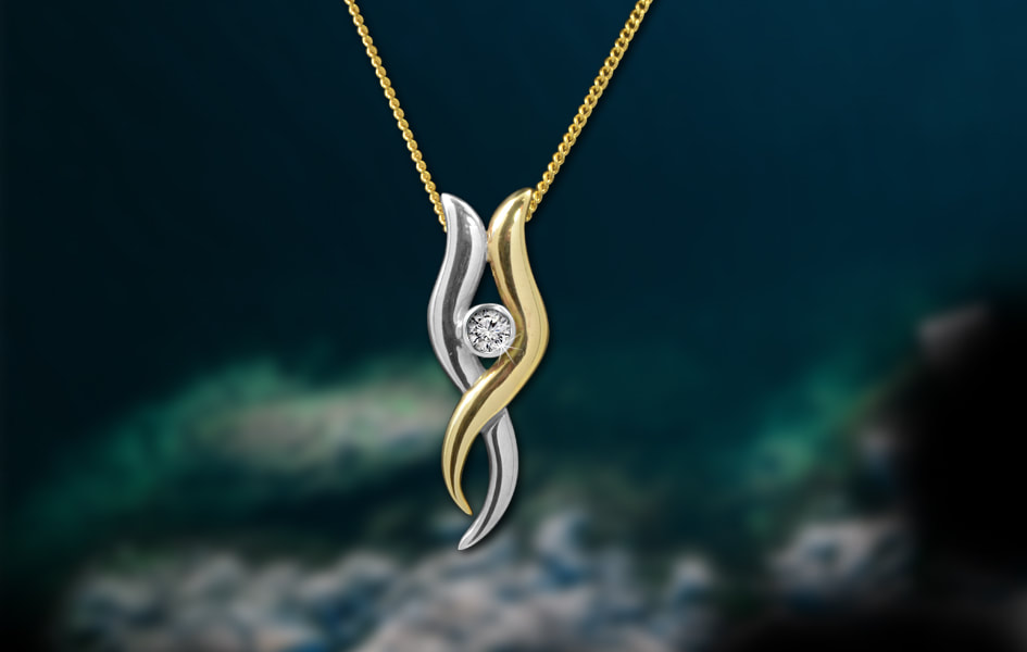 Flowing two tone gold pendant with sparkling diamond