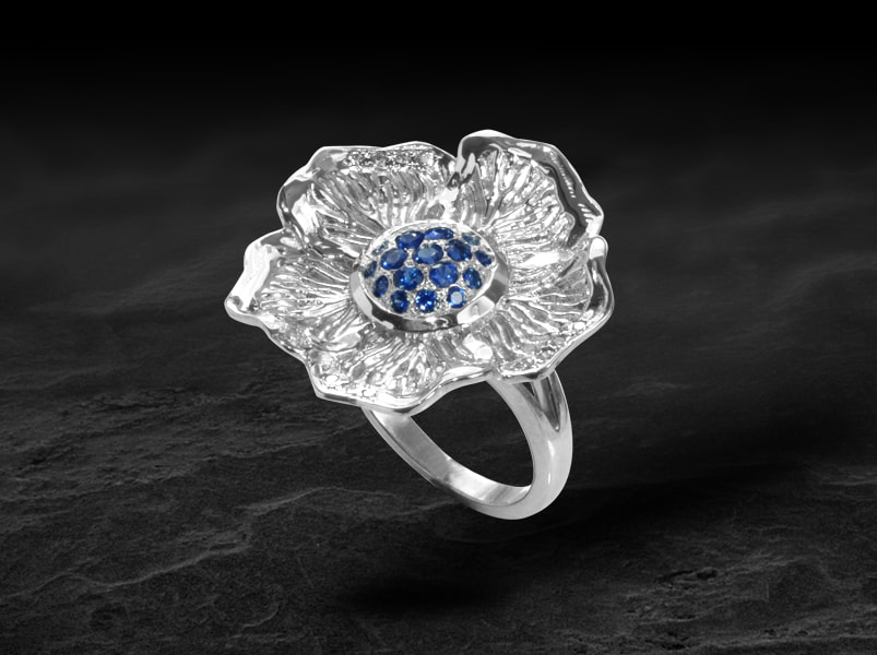Luxury hibiscus flower ring in white gold and sapphire center